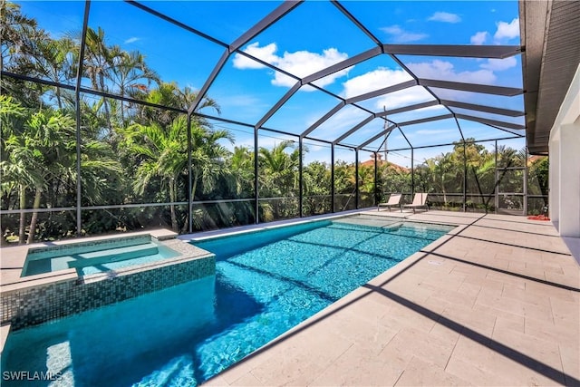 view of pool with a patio area, a lanai, and a pool with connected hot tub