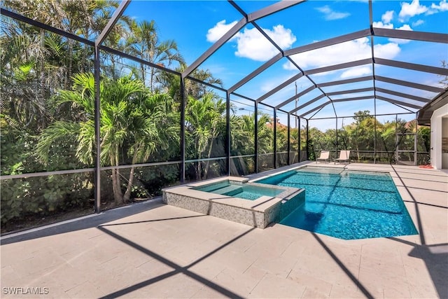 view of pool featuring a lanai, a pool with connected hot tub, and a patio
