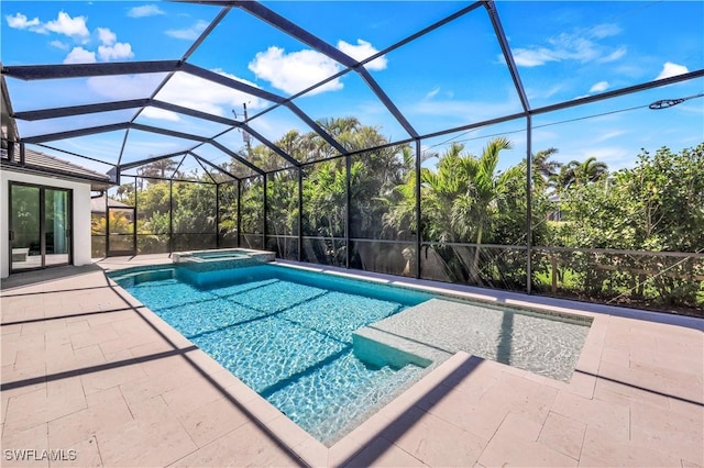 view of pool featuring a patio, a lanai, and a pool with connected hot tub