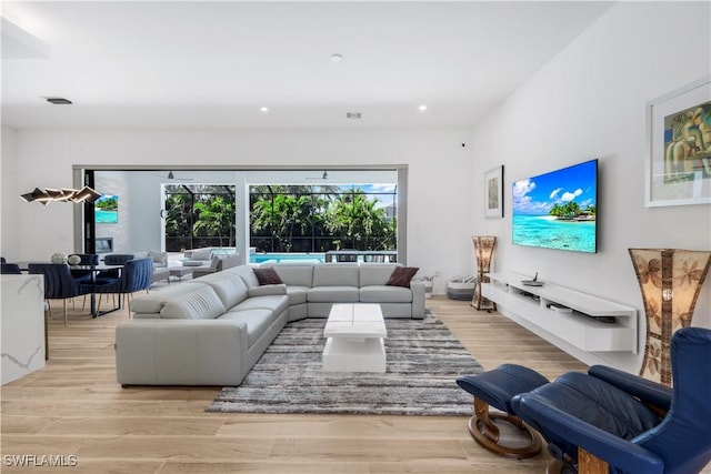 living room with recessed lighting and light wood-style floors