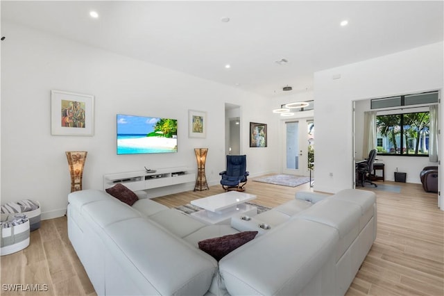 living room featuring recessed lighting, light wood-type flooring, and baseboards