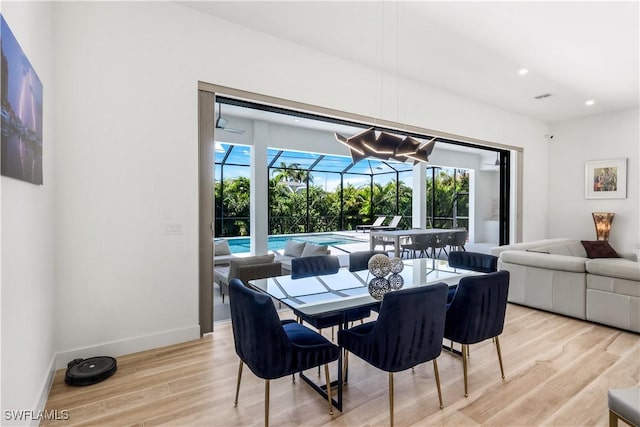 dining space with visible vents, light wood finished floors, baseboards, recessed lighting, and a sunroom