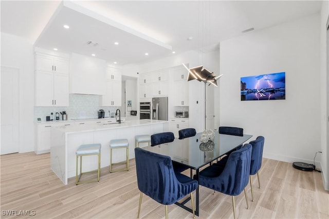 dining room featuring recessed lighting, visible vents, baseboards, and light wood finished floors