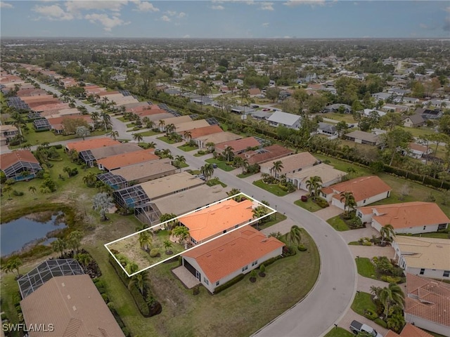 drone / aerial view featuring a residential view and a water view