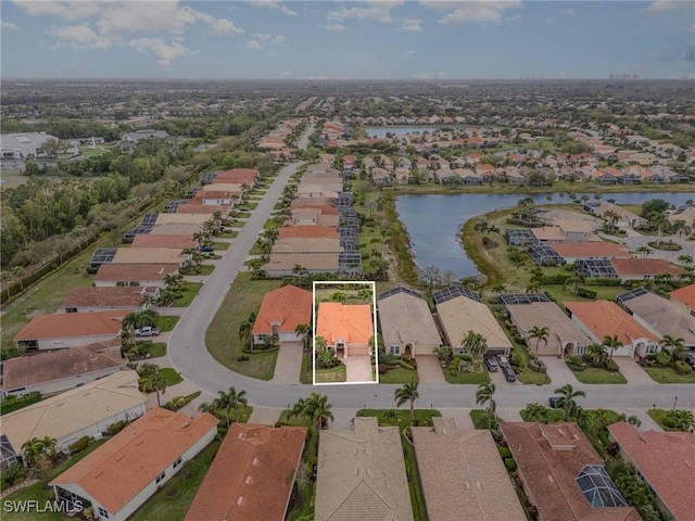 drone / aerial view featuring a residential view and a water view