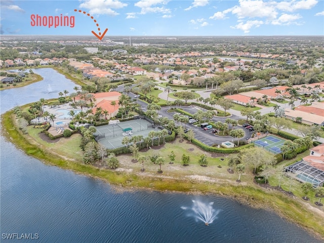 drone / aerial view featuring a residential view and a water view