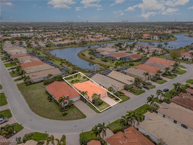 drone / aerial view featuring a residential view and a water view