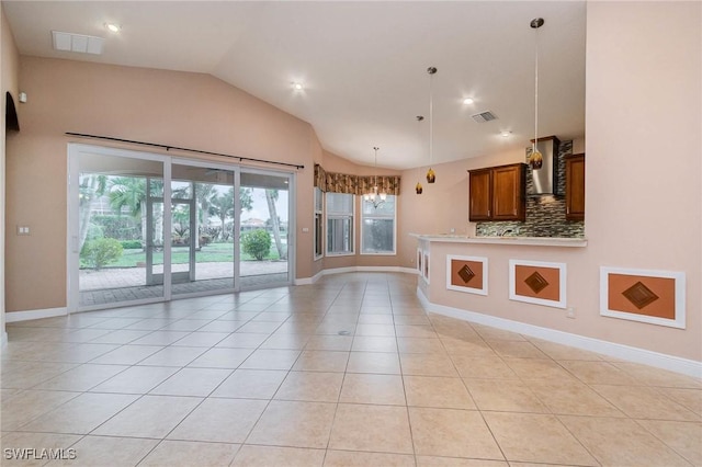 unfurnished living room with light tile patterned floors, visible vents, baseboards, and vaulted ceiling