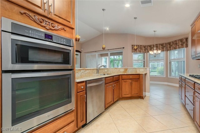 kitchen with visible vents, stainless steel appliances, brown cabinetry, light tile patterned floors, and light stone countertops