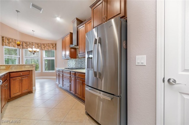 kitchen with light tile patterned floors, visible vents, lofted ceiling, stainless steel appliances, and tasteful backsplash