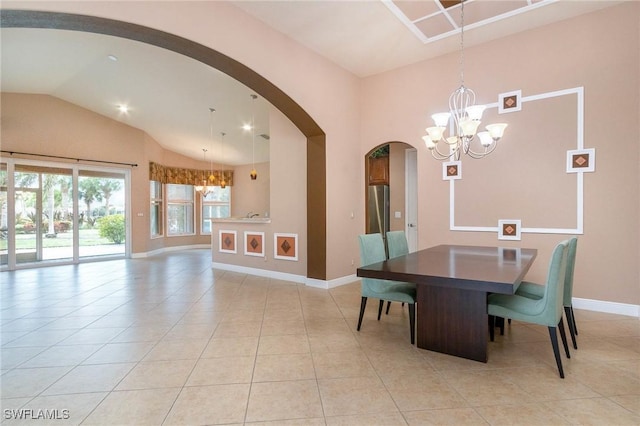 dining room with lofted ceiling, arched walkways, light tile patterned floors, baseboards, and a chandelier