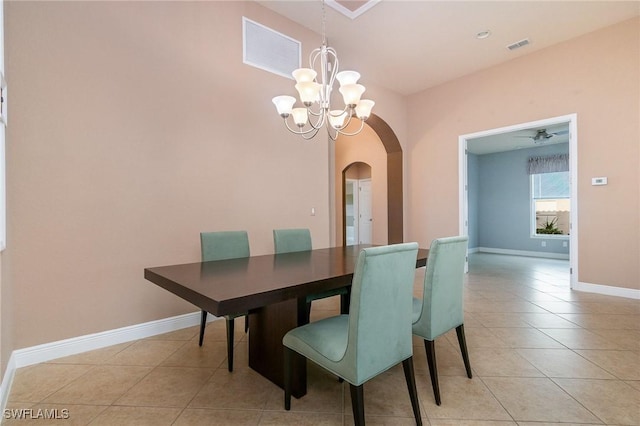 dining room with visible vents, a notable chandelier, arched walkways, light tile patterned flooring, and baseboards