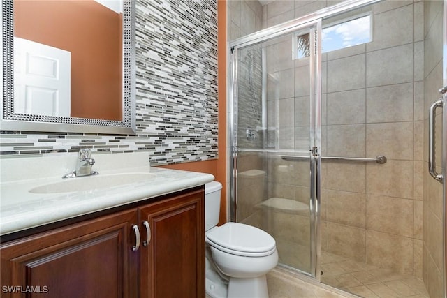 bathroom with vanity, toilet, and a shower stall