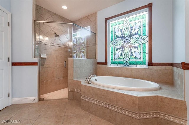 full bath with plenty of natural light, a bath, a shower stall, and tile patterned flooring