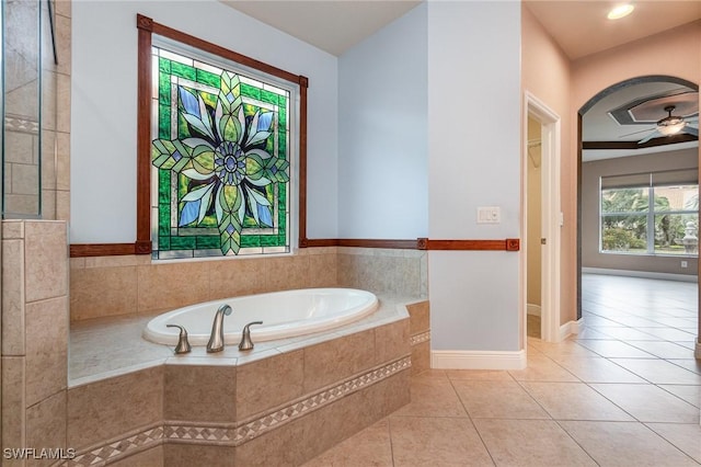 full bathroom with tile patterned floors, a bath, a ceiling fan, and baseboards