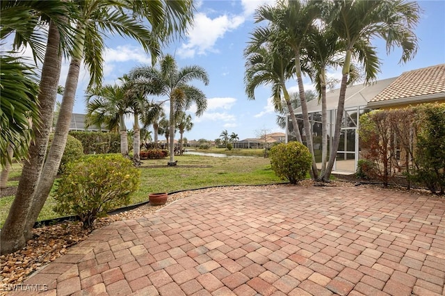 view of patio featuring glass enclosure