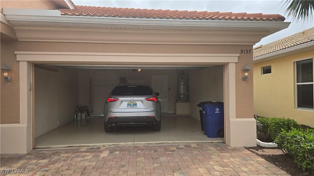 garage with decorative driveway