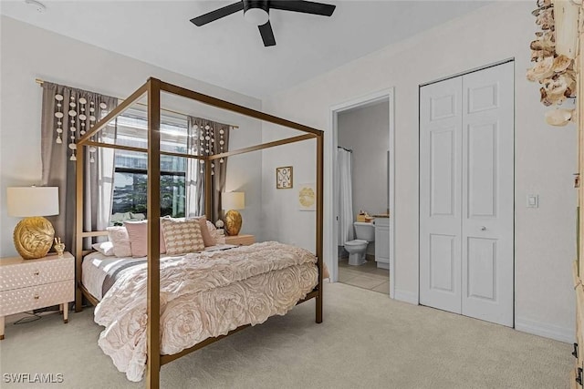 bedroom with ensuite bathroom, a ceiling fan, and carpet flooring