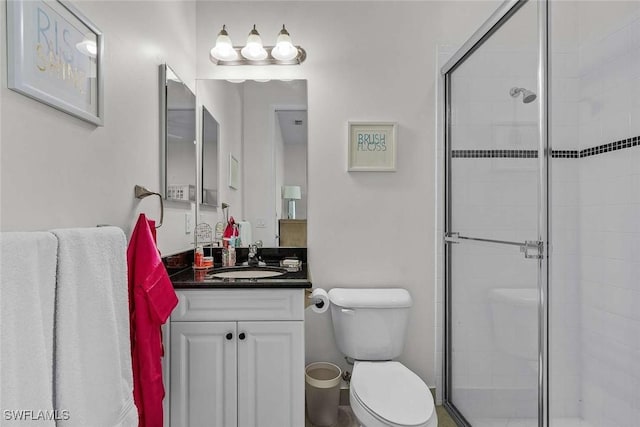 full bath featuring vanity, toilet, and a shower stall