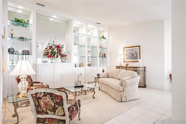 living room featuring built in features, visible vents, and tile patterned flooring