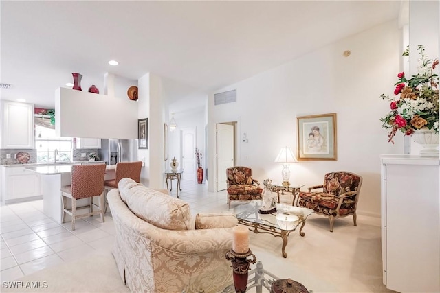 living area with light tile patterned floors and visible vents