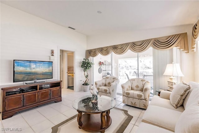 living room with light tile patterned floors and visible vents