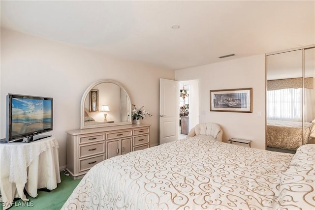 bedroom with a closet, carpet flooring, and visible vents