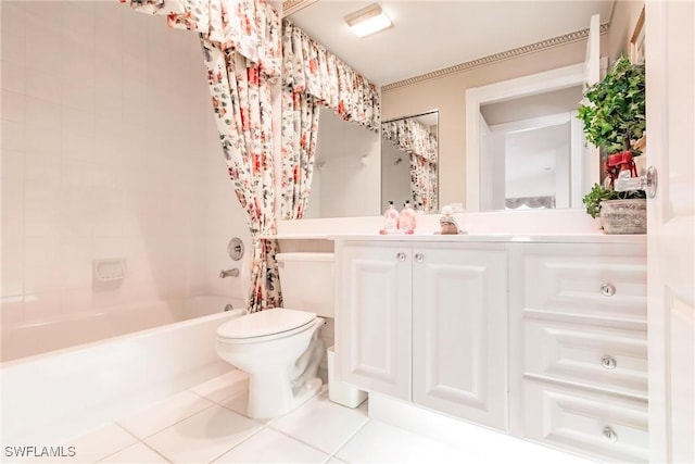 bathroom featuring toilet, shower / tub combo with curtain, vanity, and tile patterned flooring