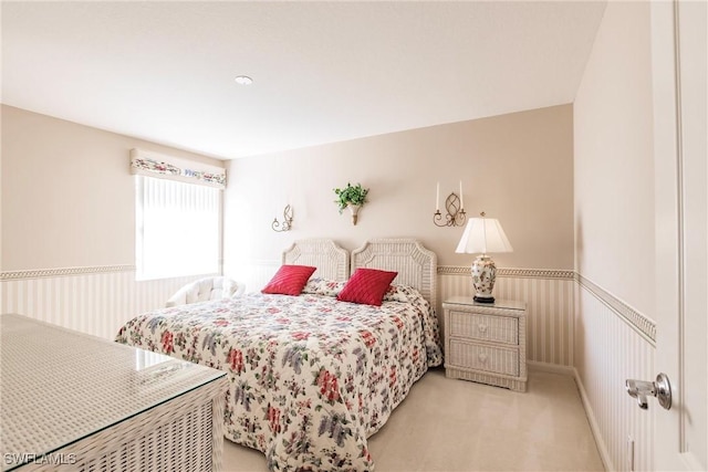 carpeted bedroom with wainscoting