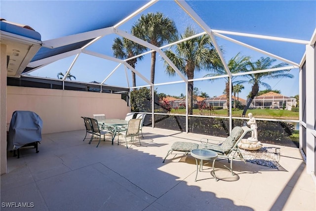 view of patio featuring outdoor dining space and glass enclosure