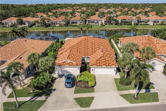 drone / aerial view with a residential view and a water view