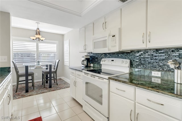 kitchen featuring tasteful backsplash, a chandelier, white appliances, and white cabinetry