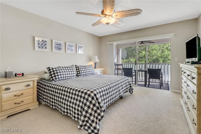 bedroom featuring a textured ceiling, light colored carpet, a ceiling fan, and access to outside