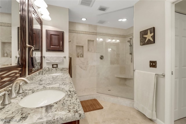 bathroom with visible vents, a stall shower, and a sink