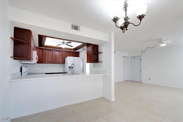 kitchen with open shelves, visible vents, white appliances, and light countertops