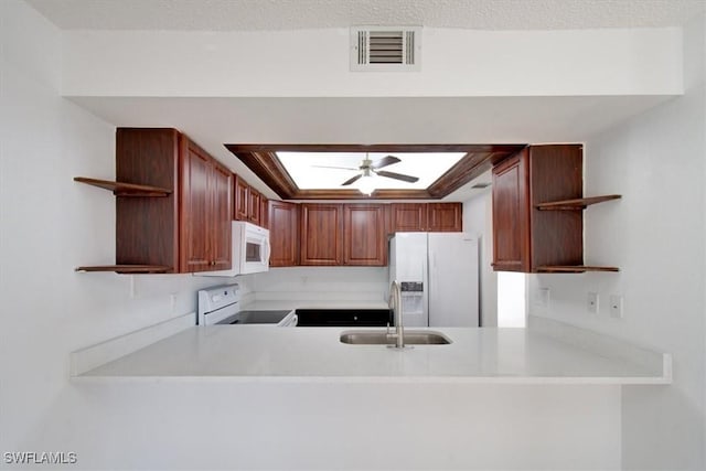 kitchen featuring open shelves, visible vents, white appliances, and a sink