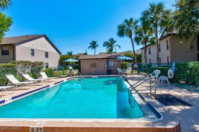 pool featuring a patio and fence