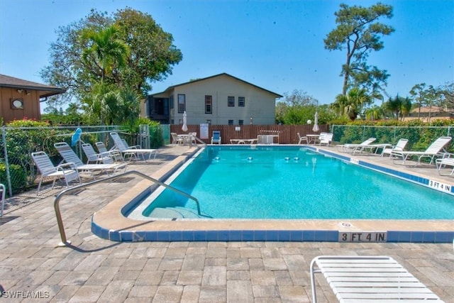 pool featuring a patio area and fence