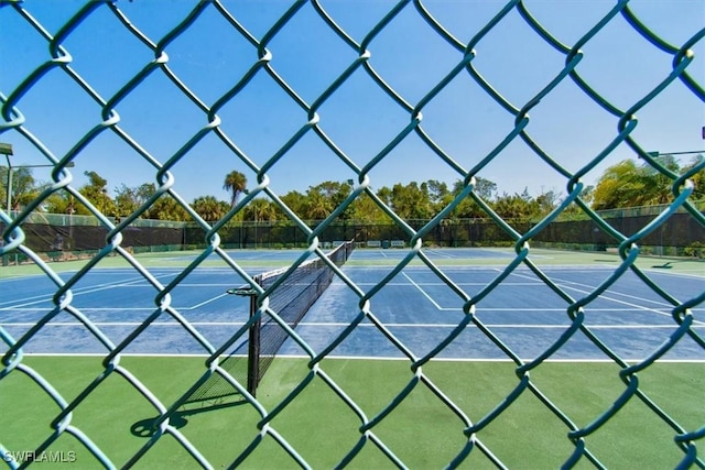 view of sport court featuring fence