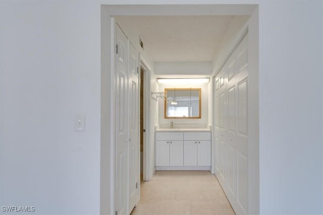 corridor featuring a sink and visible vents