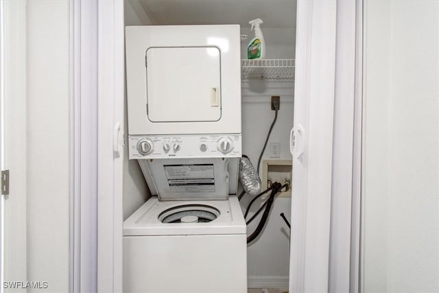 clothes washing area with laundry area and stacked washer and clothes dryer