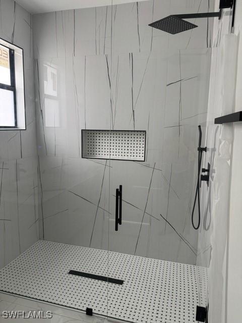 bathroom with a marble finish shower