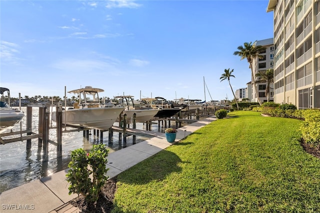 dock area featuring a yard, a water view, and boat lift