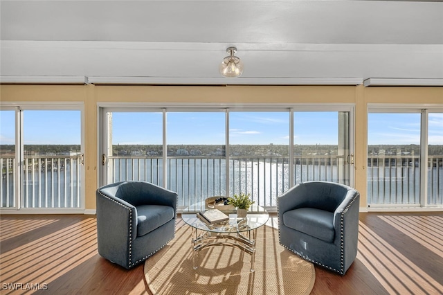 sunroom featuring plenty of natural light and a water view