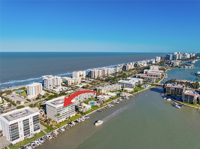 drone / aerial view featuring a city view and a water view