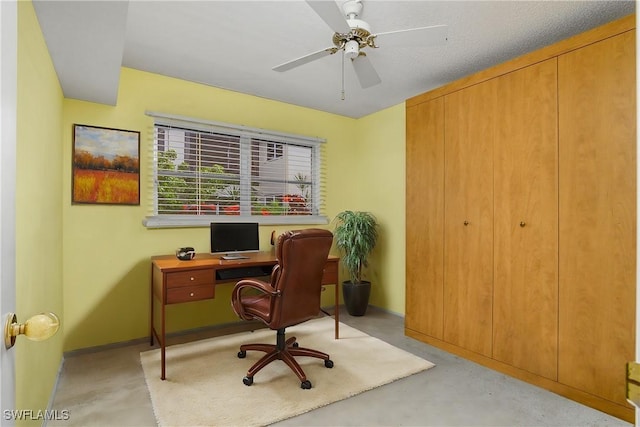 office space with baseboards, concrete floors, and ceiling fan