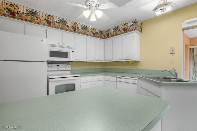 kitchen with white cabinets, white appliances, light countertops, and a sink