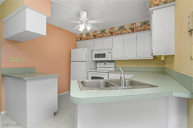 kitchen featuring a sink, white appliances, a peninsula, light tile patterned flooring, and light countertops