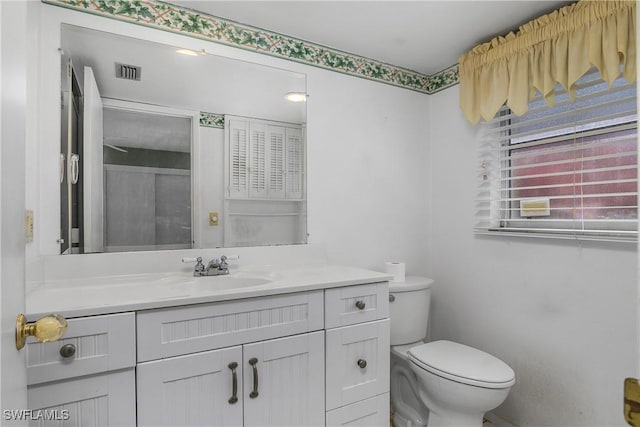 bathroom with visible vents, toilet, and vanity