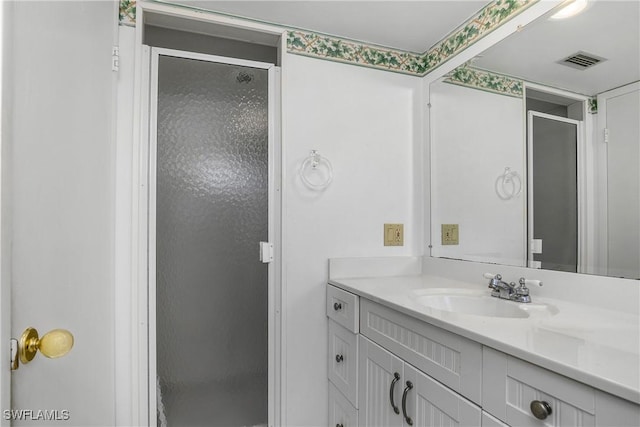 full bath with visible vents, a shower stall, and vanity